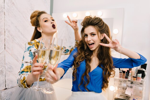 Portrait joyful excited young women having fun in hairdresser salon