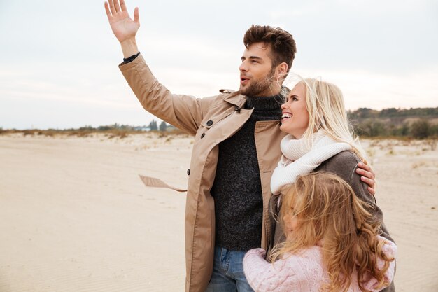 Portrait of a joyful family with a little daughter