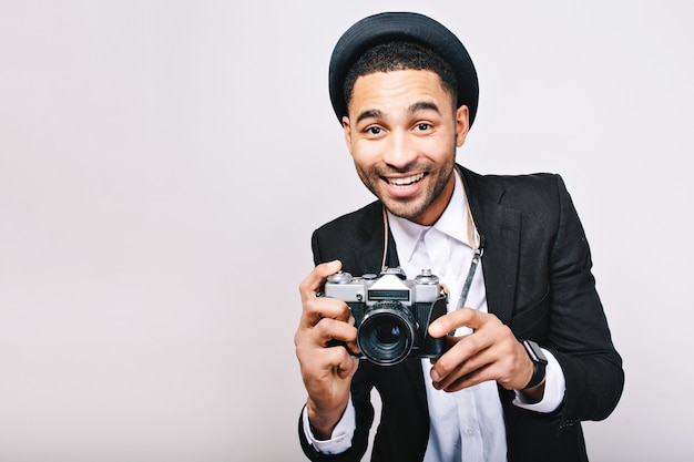 Portrait joyful successful guy in suit, hat having fun with camera. Happy tourist, photographer, stylish look, travelling, smiling, excited, isolated.