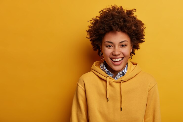Free Photo portrait of joyful teenager laughs sincerely, wears casual hoodie