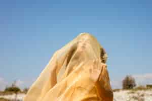 Free photo portrait of joyful woman with yellow cloth in nature