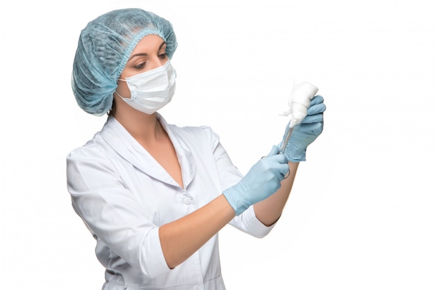 Portrait of lady surgeon holding surgical instrument over white background