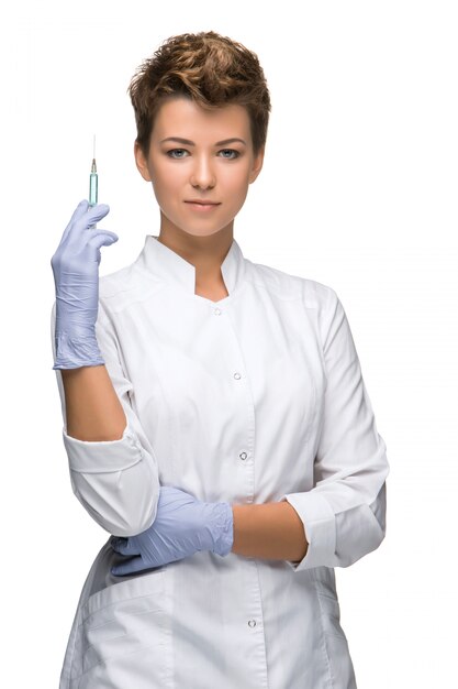 Portrait of lady surgeon showing syringe