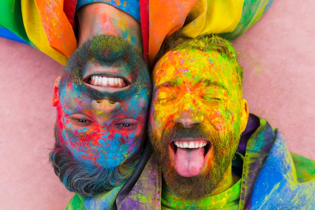 Portrait of laughing gay pair soiled in paint