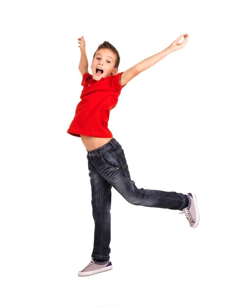 Portrait of laughing happy boy jumping with raised hands up isolated on white