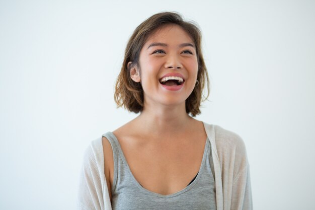 Portrait of laughing young Asian woman