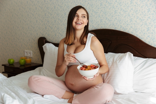 Portrait of a laughing young pregnant woman