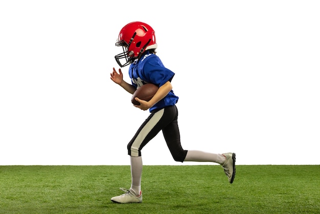 Portrait of little boy child playing training american football isolated over white studio background