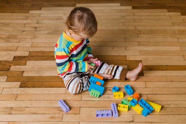 Portrait little boy playing with toys 