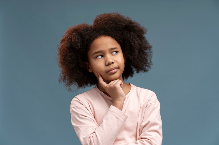 Free Photo portrait of little cute girl thinking of something
