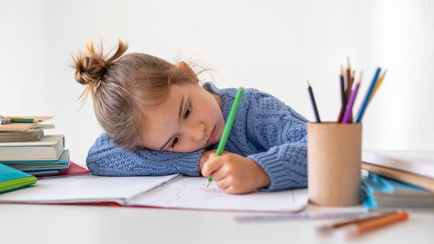 Free photo portrait little girl coloring