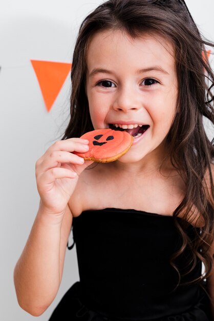 Portrait of a little girl eating a cookie