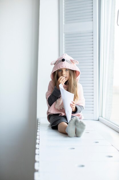 Portrait of little girl wearing pink pullover