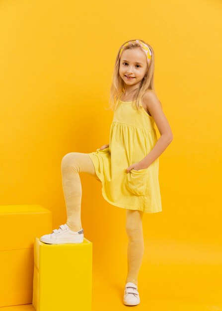 Portrait little girl wearing yellow  dress