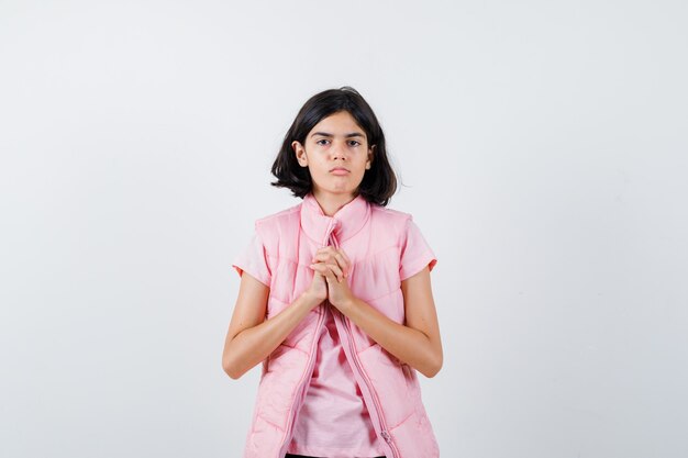 Portrait of a little girl in white t-shirt and puffer vest