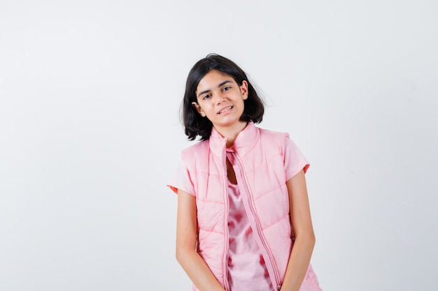 Portrait of a little girl in white t-shirt and puffer vest