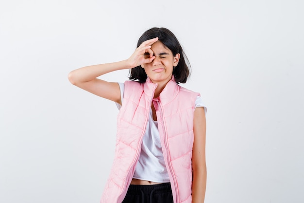 Portrait of a little girl in white t-shirt and puffer vest