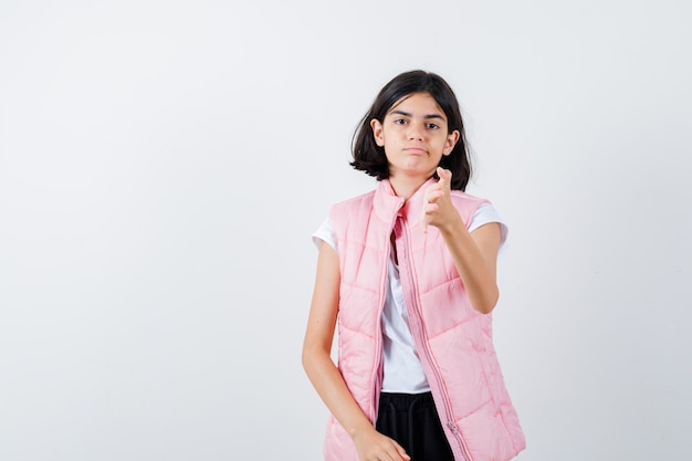 Portrait of a little girl in white t-shirt and puffer vest