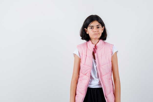 Portrait of a little girl in white t-shirt and puffer vest