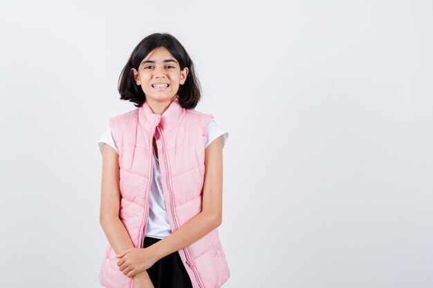 Portrait of a little girl in white t-shirt and puffer vest