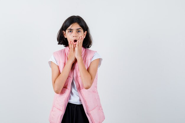 Portrait of a little girl in white t-shirt and puffer vest