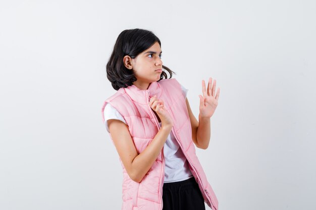 Portrait of a little girl in white t-shirt and puffer vest