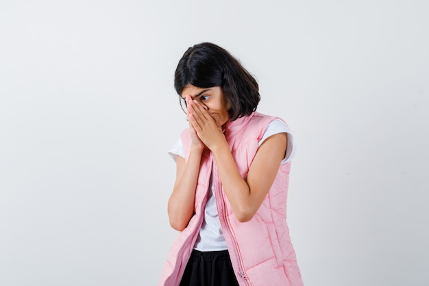 Portrait of a little girl in white t-shirt and puffer vest