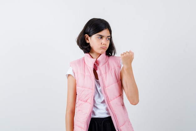 Portrait of a little girl in white t-shirt and puffer vest