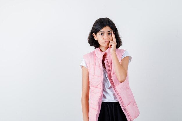 Portrait of a little girl in white t-shirt and puffer vest