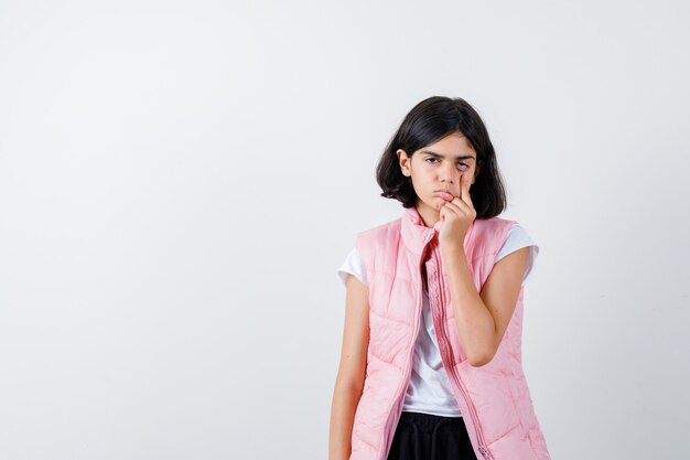 Portrait of a little girl in white t-shirt and puffer vest