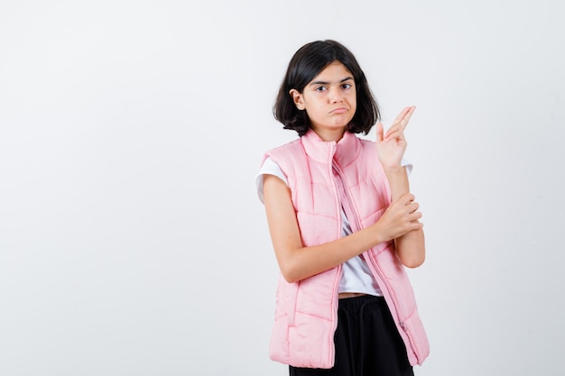 Portrait of a little girl in white t-shirt and puffer vest