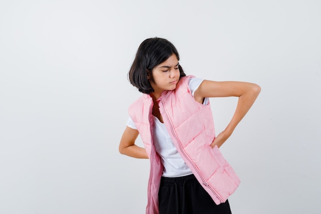 Portrait of a little girl in white t-shirt and puffer vest