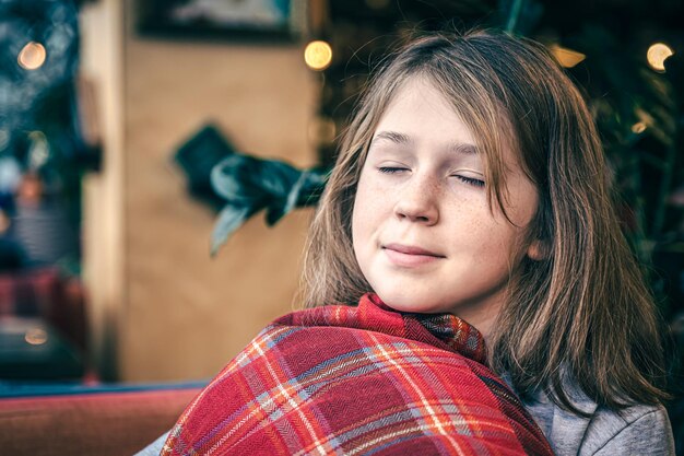 Portrait of a little girl with a pillow in a beautiful interior