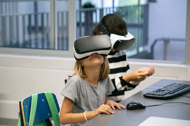 Free photo portrait of little kids using vr headsets and having fun