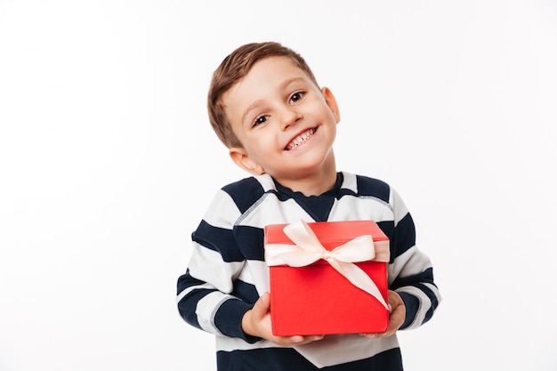 Portrait of a lovely cute little kid holding present box