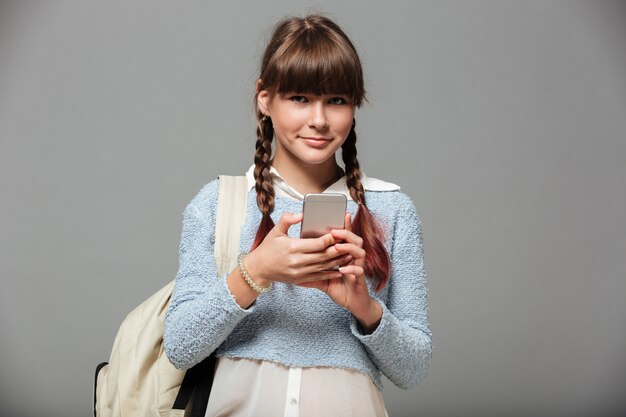 Portrait of a lovely smiling schoolgirl with backpack