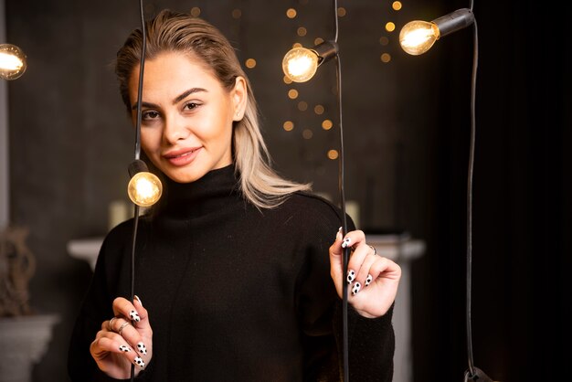 Portrait of lovely woman in black sweater standing and posing.