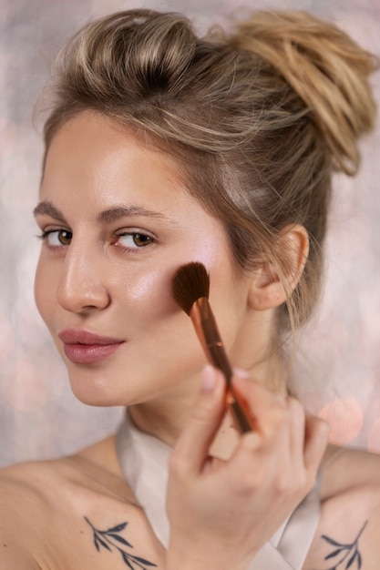 Free photo portrait of makeup artist applying products