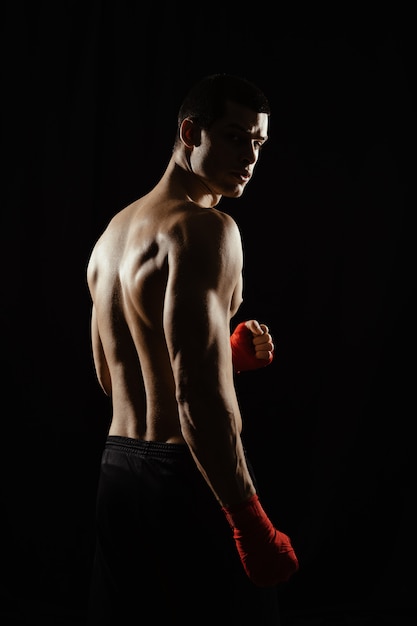 Portrait of male boxer looking over shoulder