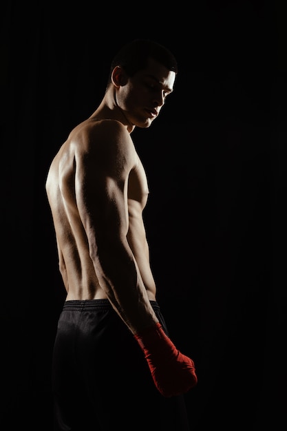 Portrait of male boxer looking over shoulder