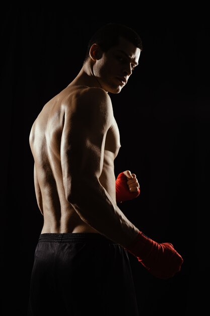 Portrait of male boxer looking over shoulder