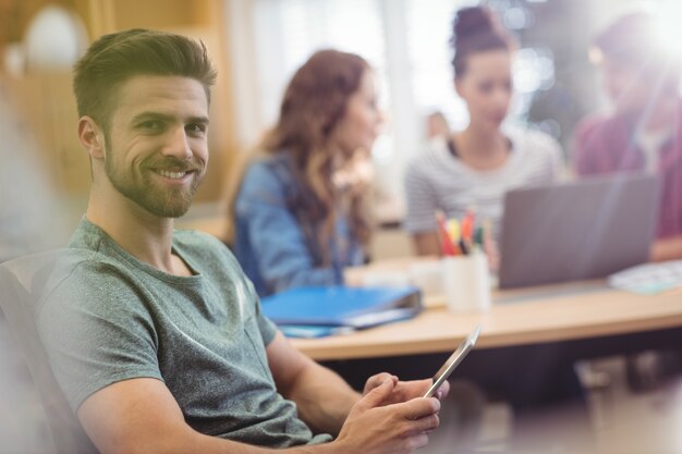 Portrait of male business executive holding digital tablet