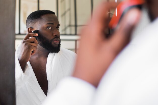 Portrait of male shaving his beard