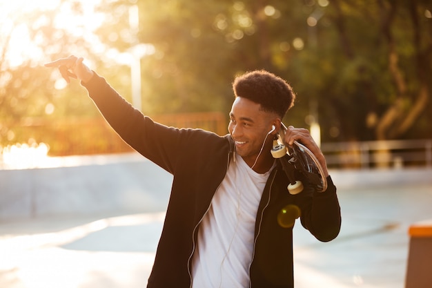 Portrait of a male teenager guy holding skateboard