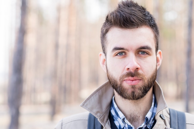 Portrait of a male traveler looking at camera outdoors