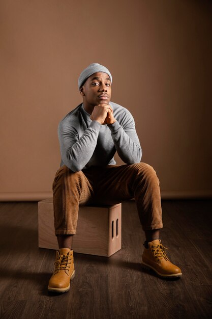 Portrait male wearing cap sitting