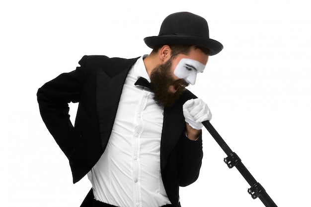 Free photo portrait of a man as mime with tube or retro style microphone