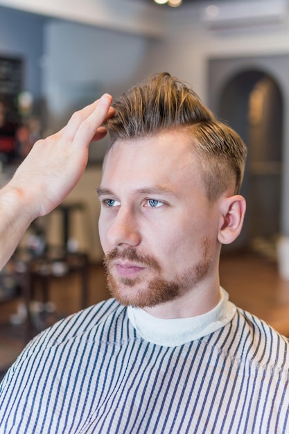 Free photo portrait of man in barbershop with classic styling