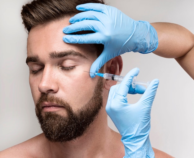 Portrait of man being injected in his face