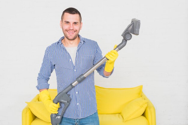 Portrait of man cleaning his house